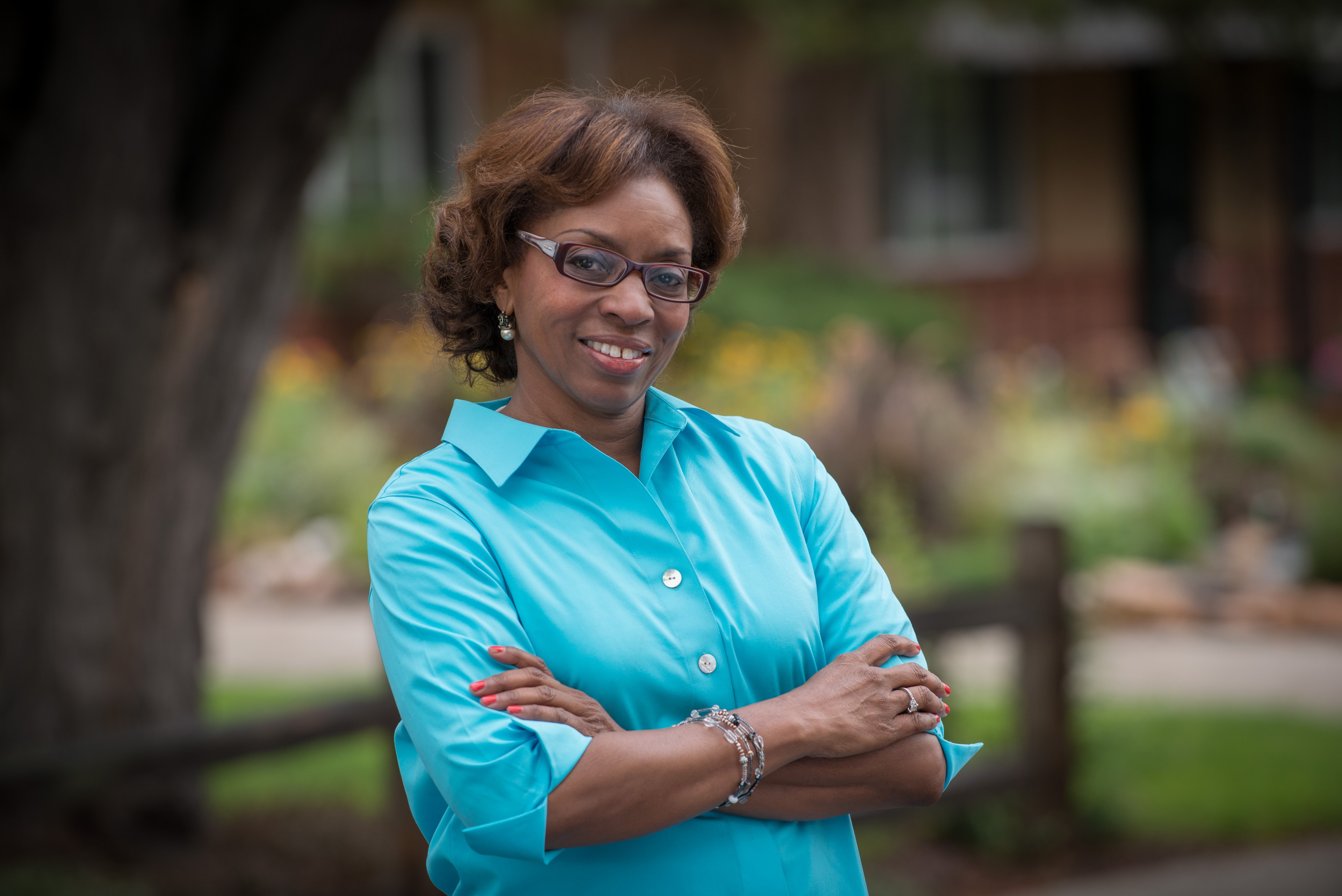Arapahoe County Commissioner Rhonda Fields smiling with arms crossed outdoors